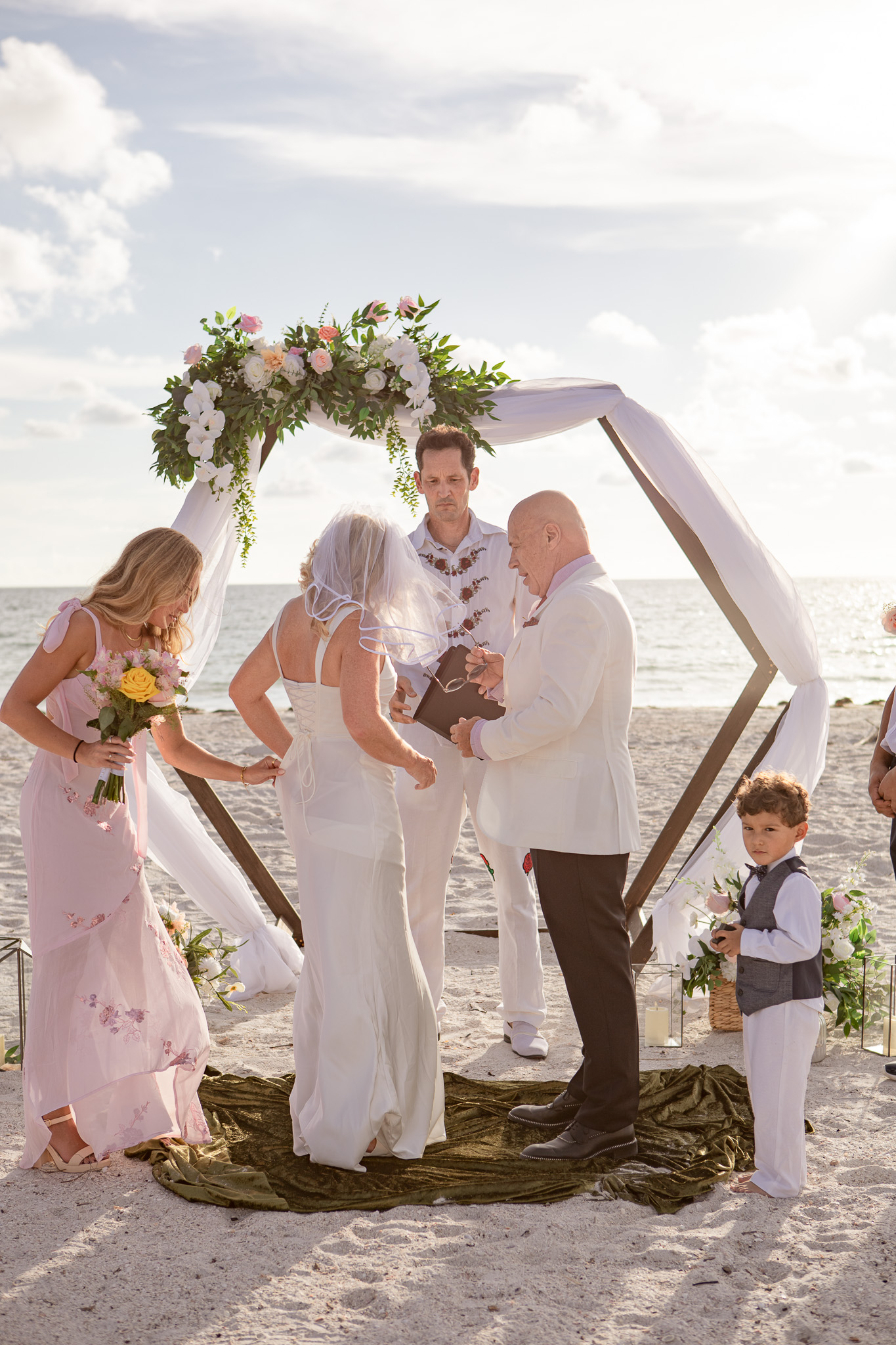 Two couples piggyback, laughing along the shoreline