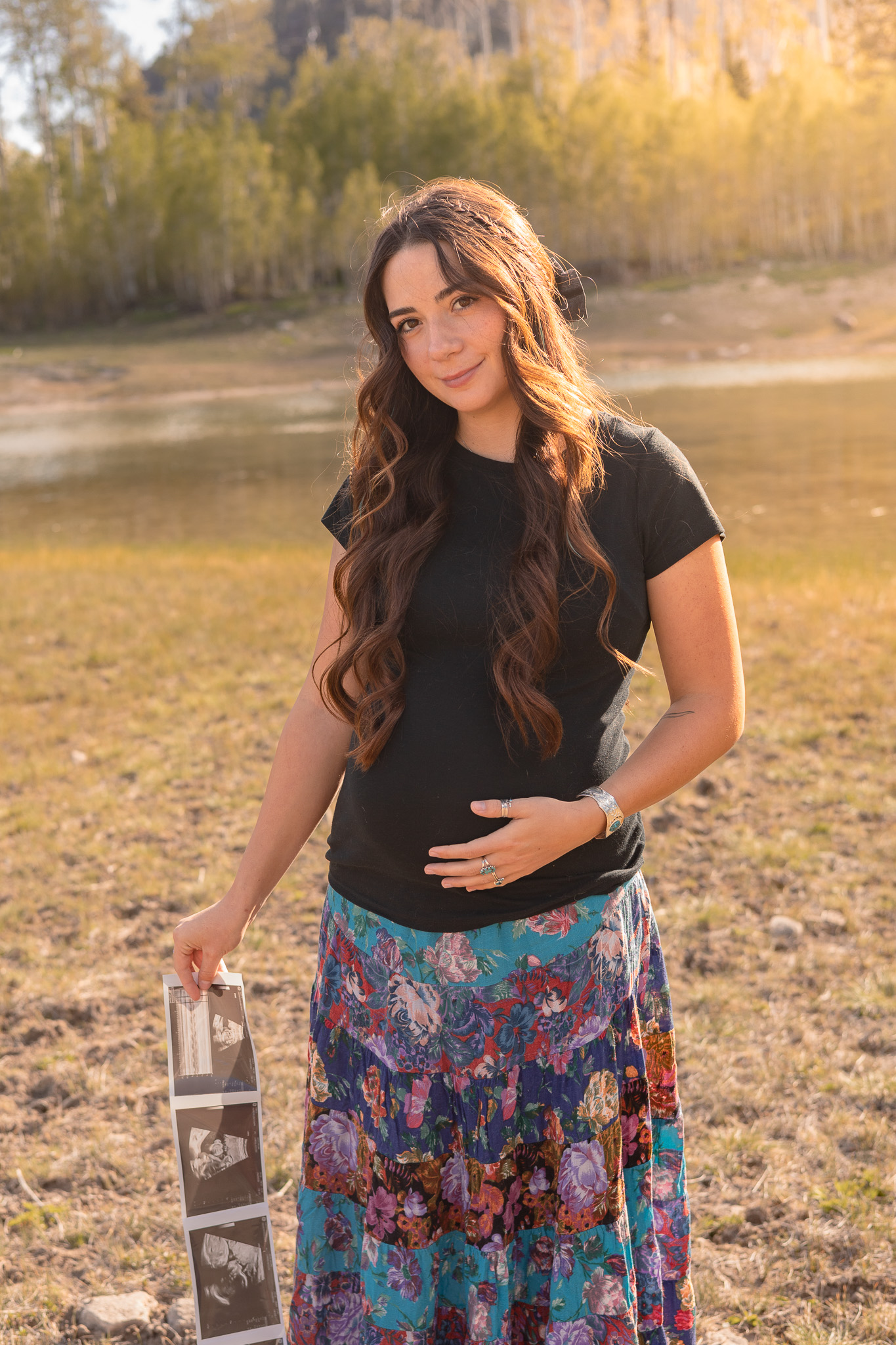 Sunflowers tucked at her waist, laughing in the field