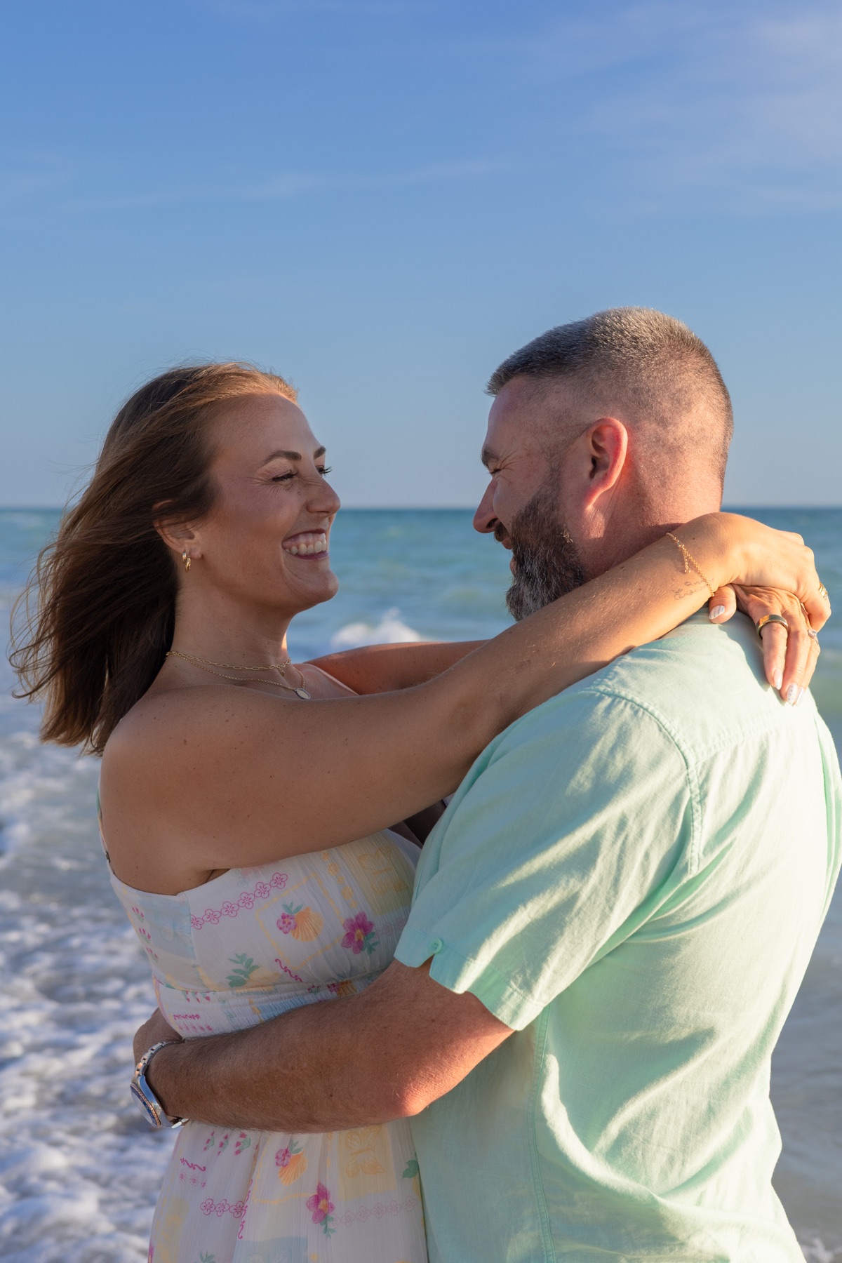 Couple laughing face-to-face in the surf