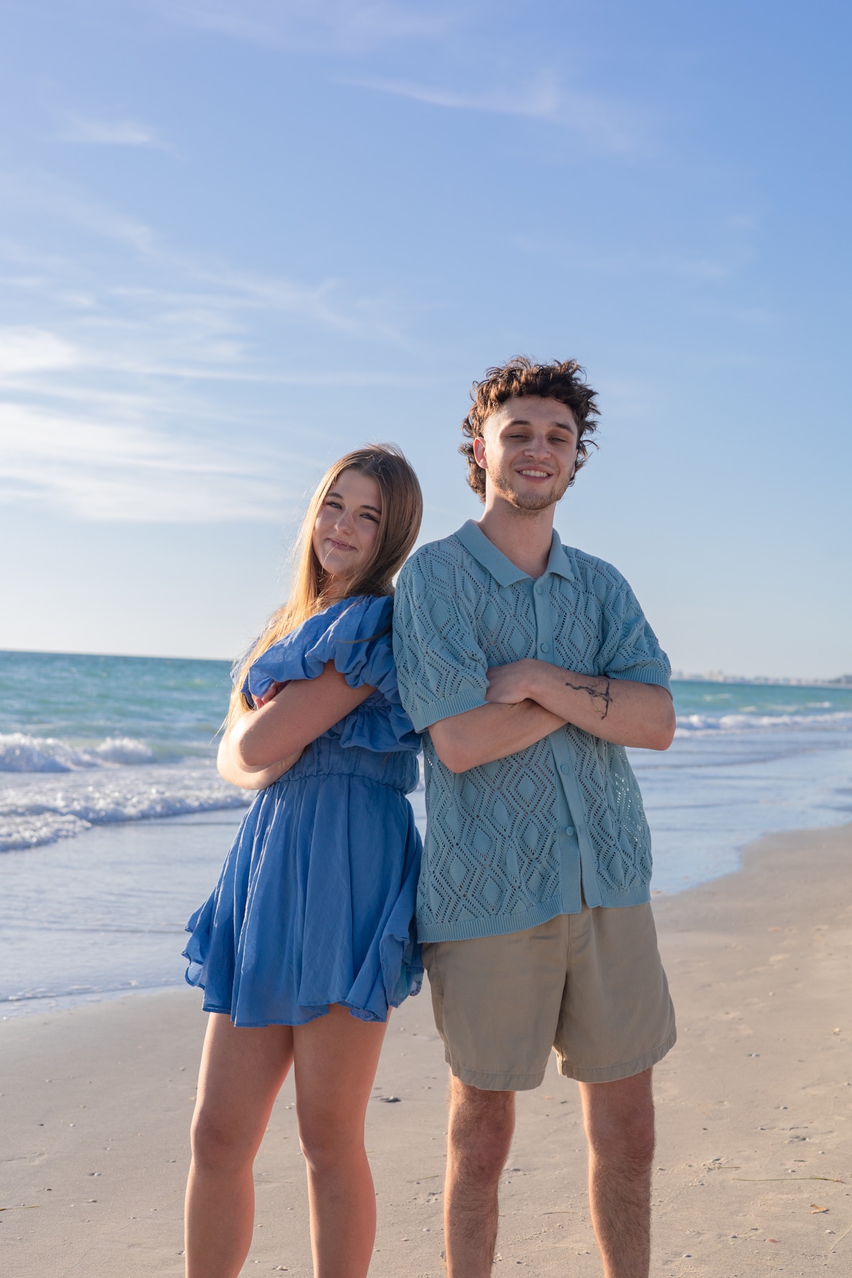 Siblings back-to-back in the late golden light