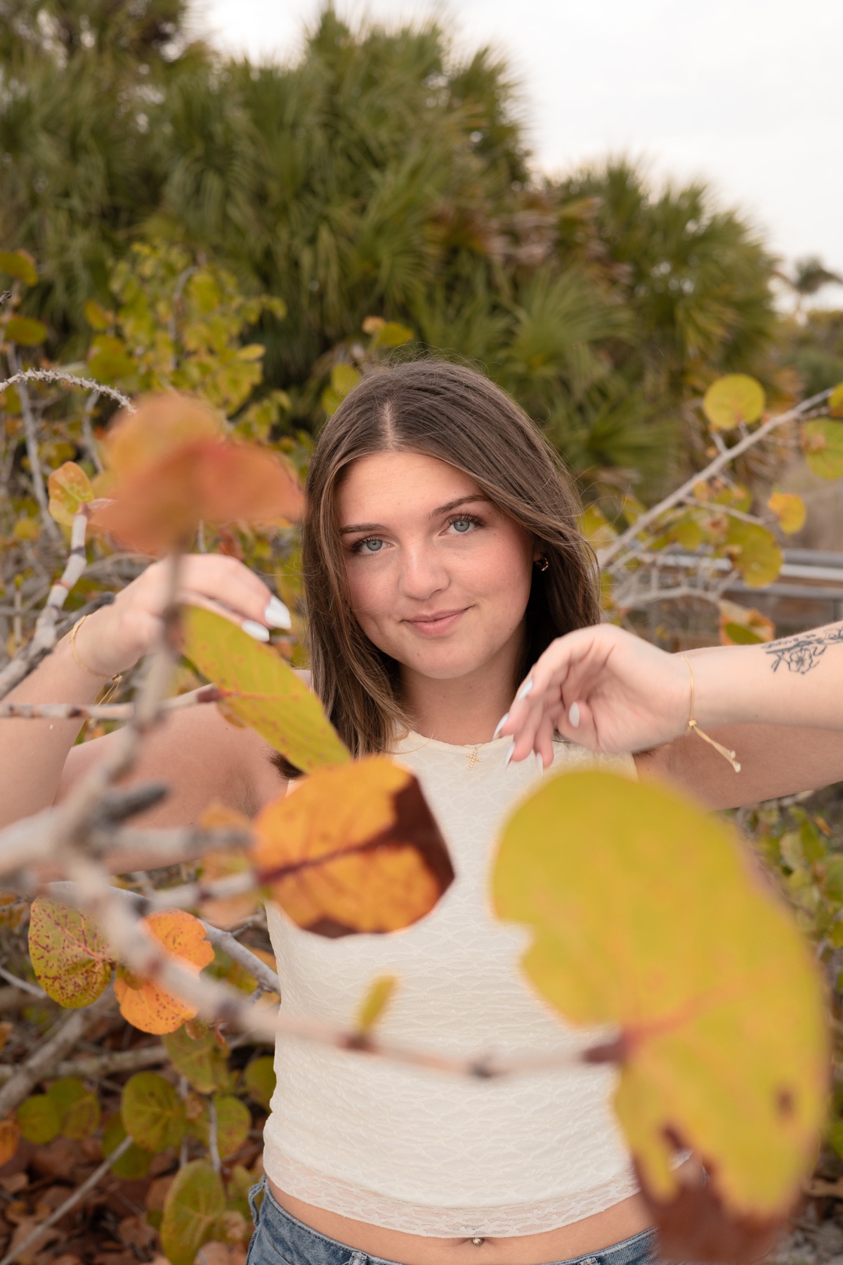Senior portrait framed by sea-grape leaves
