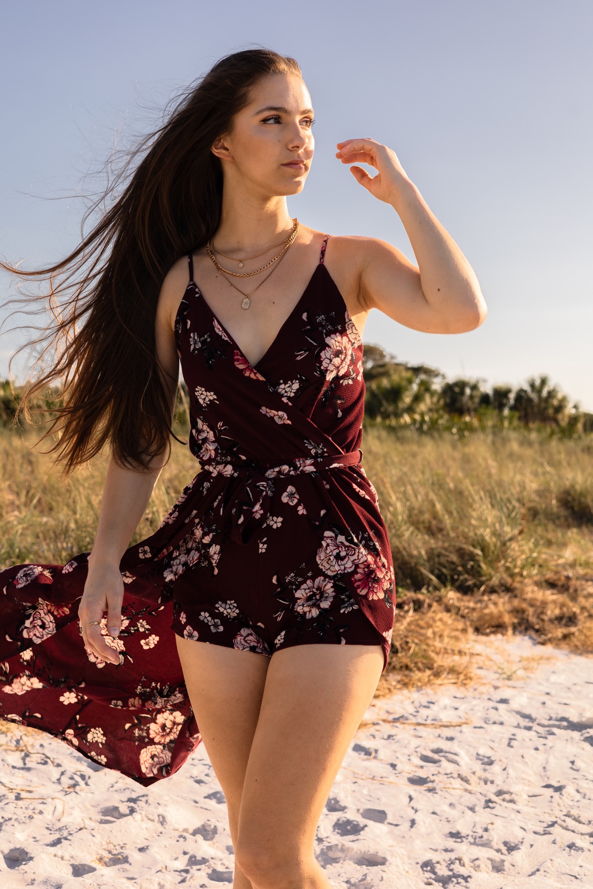Floral romper twirling in the dune grass
