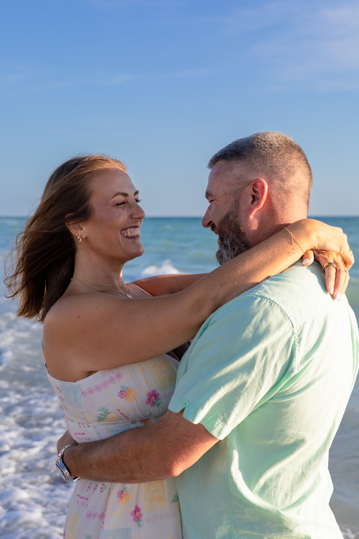 Couple's joyful embrace under a bright Florida sky